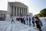 Visitors wait outside the Supreme Court in Washington, on June 20, 2013, in anticipation of key decisions being announced