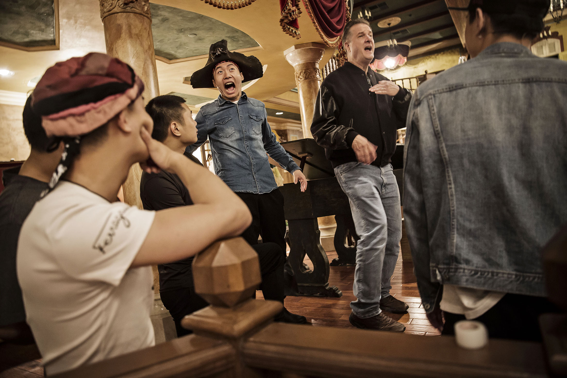 Performers share a light moment during the rehearsal of Jack Sparrow's Stunt Spectacular in Treasure Cove at the Shanghai Disney Resort.