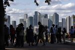 Visitors at a viewing spot overlooking the Canary Wharf financial, business and shopping district in London, UK, on Tuesday, Aug. 20, 2024. Hundreds of financial firms are struggling to comply with a new UK regime designed to rein in online payment scams before an Oct. 7 deadline after one of the worst summers for fraud.
