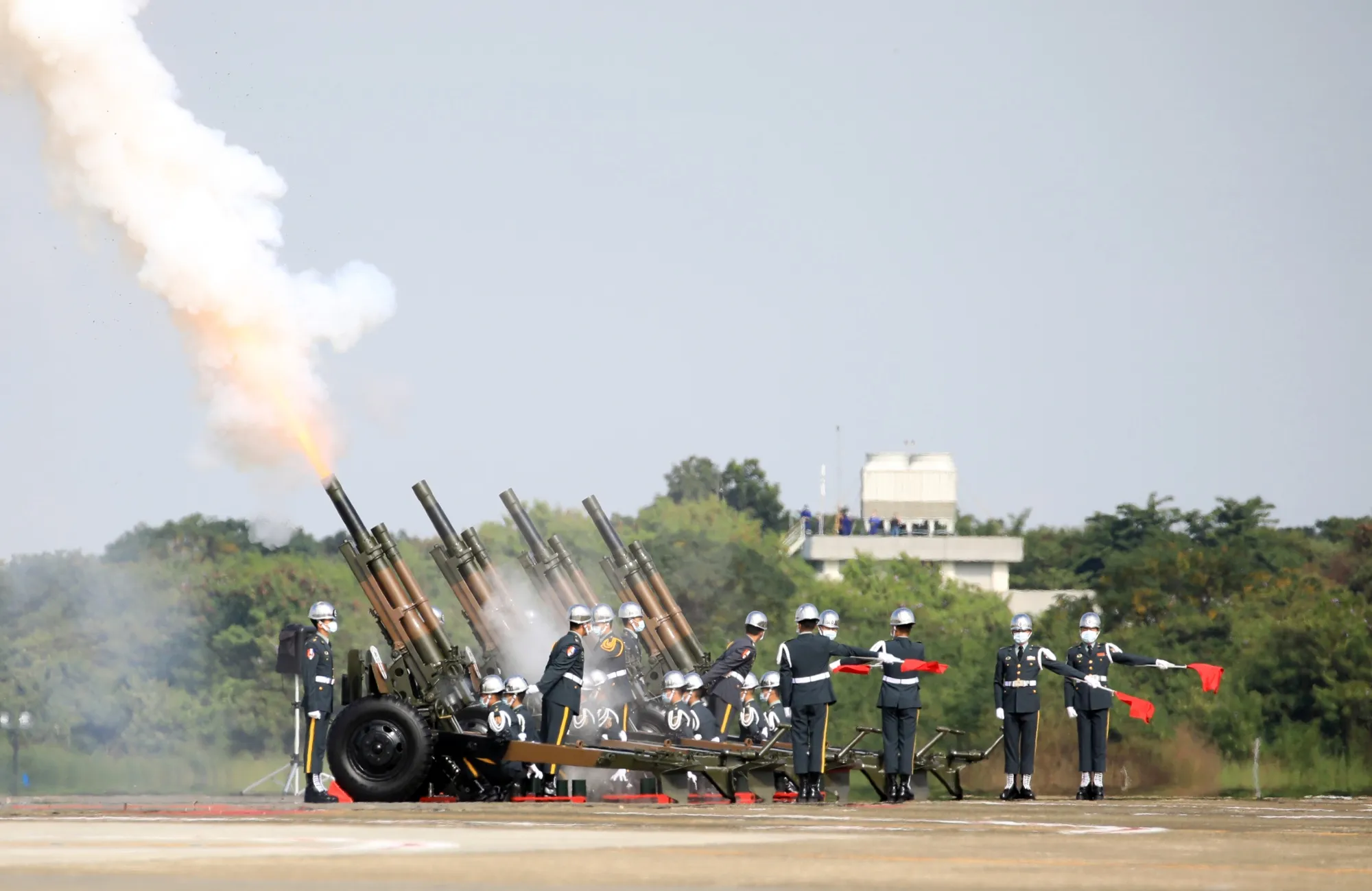 An honor guard fires weapons during a ceremony today as the Taiwanese Air Force officially put upgraded fighter jets into service.