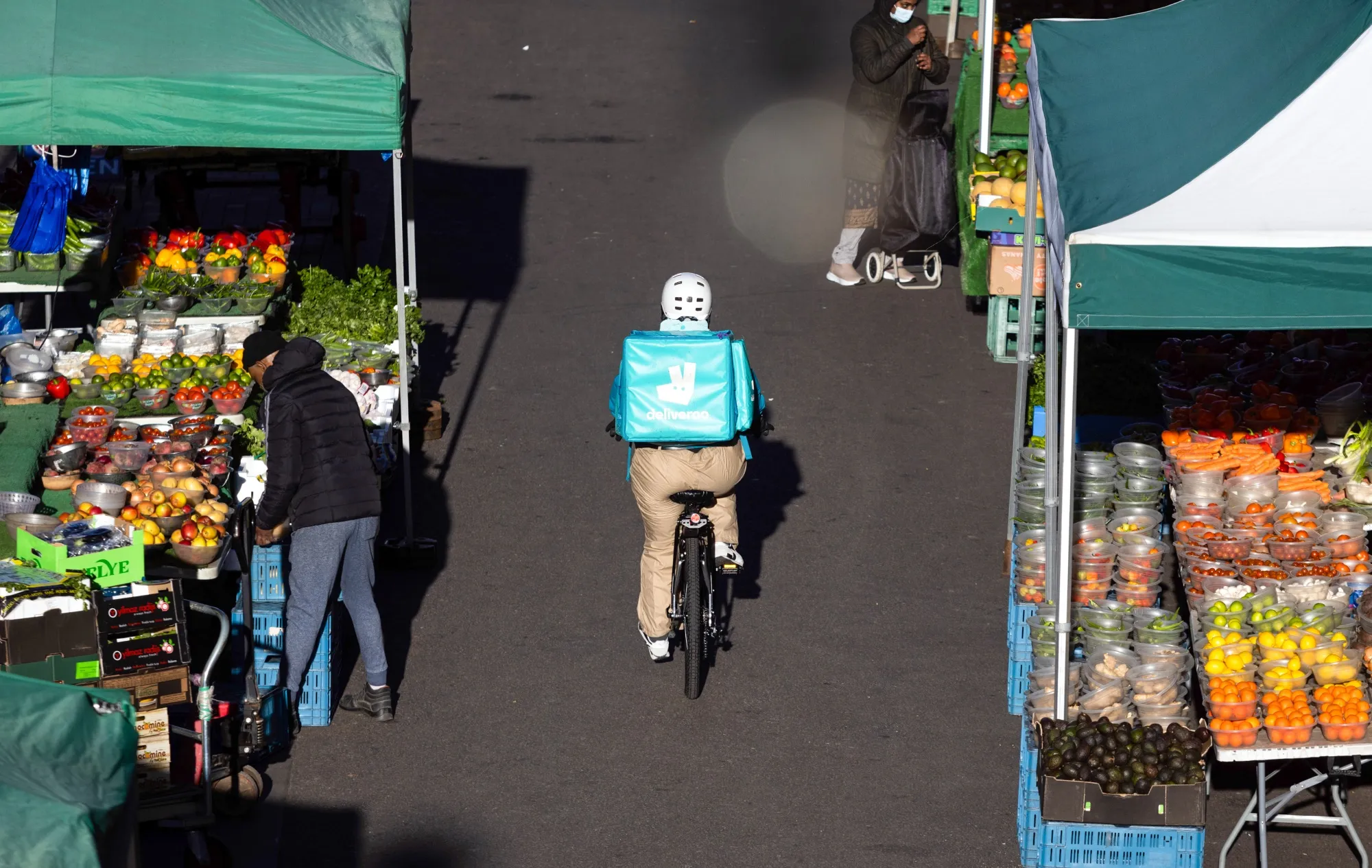 A Deliveroo courier cycles in Croydon, Greater London.