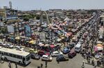 Traffic passes by Makola market in Accra, Ghana.