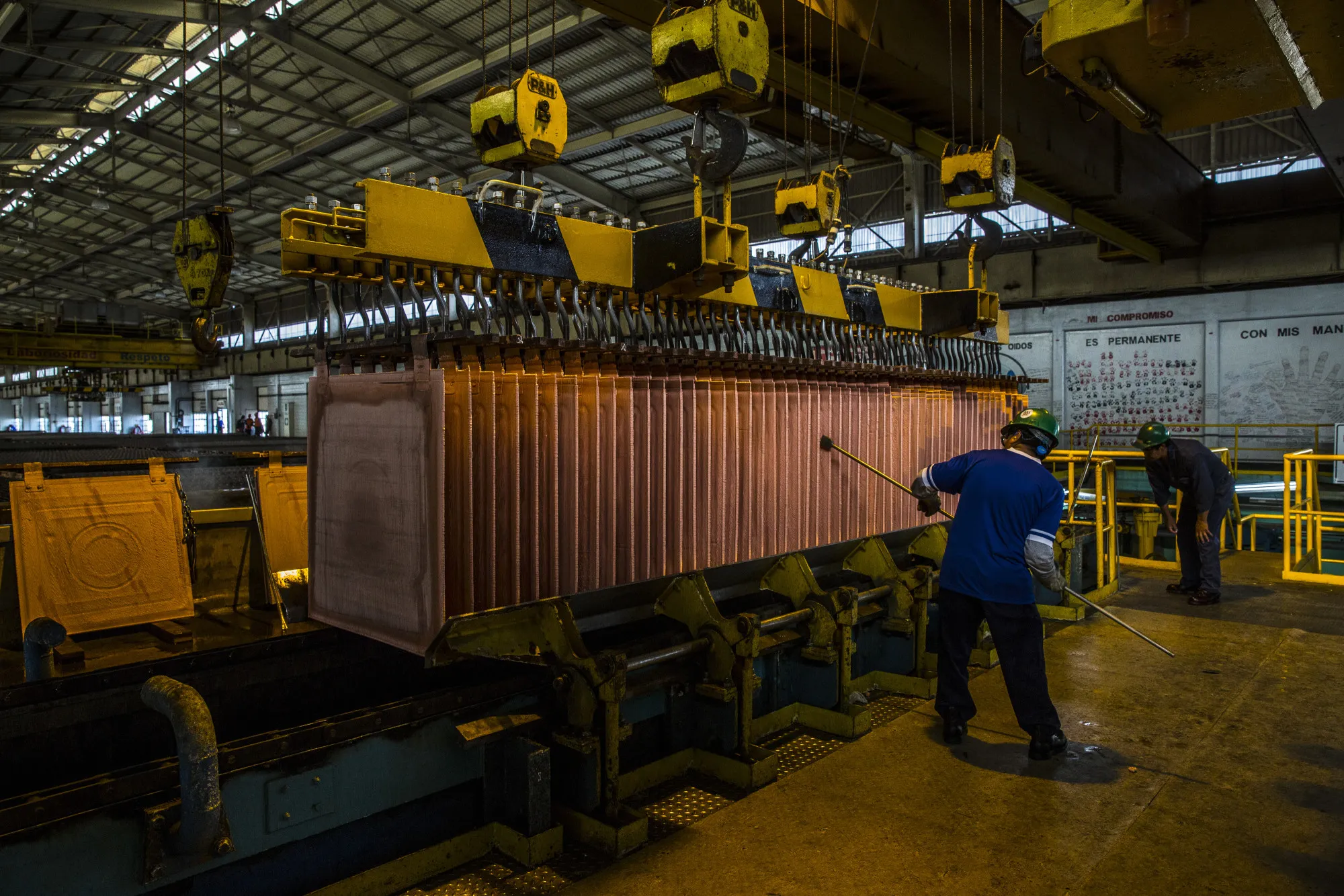 Employees remove copper debris during the electrolytic refining process of copper at the Southern Copper Corp. refinery in Ilo, Peru.