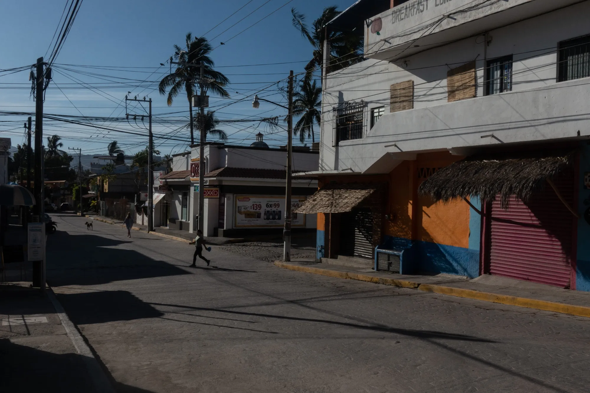 A pedestrian walks past closed businesses in the town of Bucerias, Mexico on April 23.