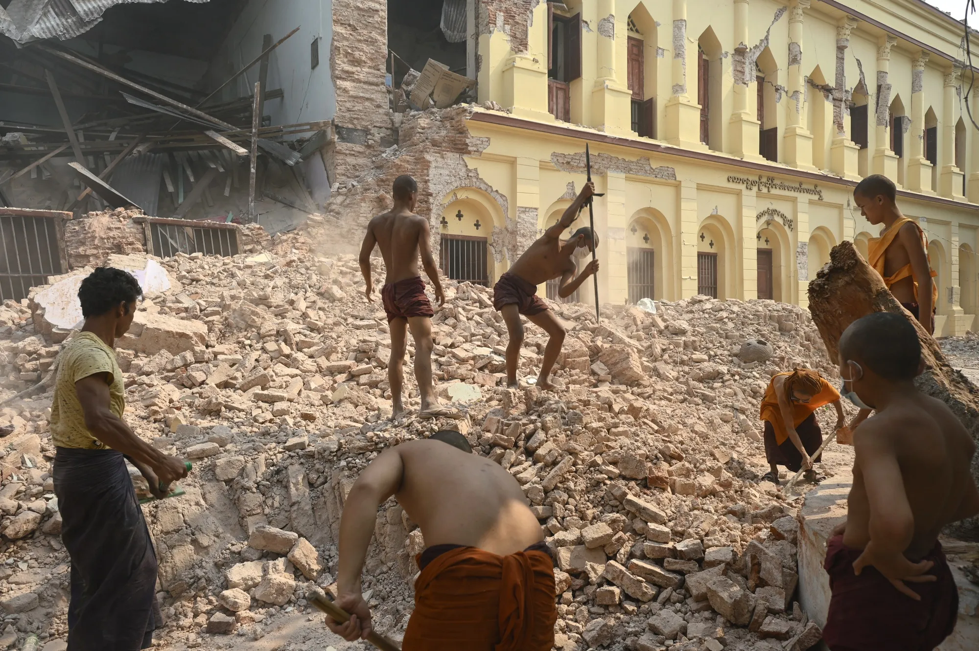 Buddhist monks clear up rubble at the damaged Thahtay Kyaung Monastery in Mandalay on April 1.