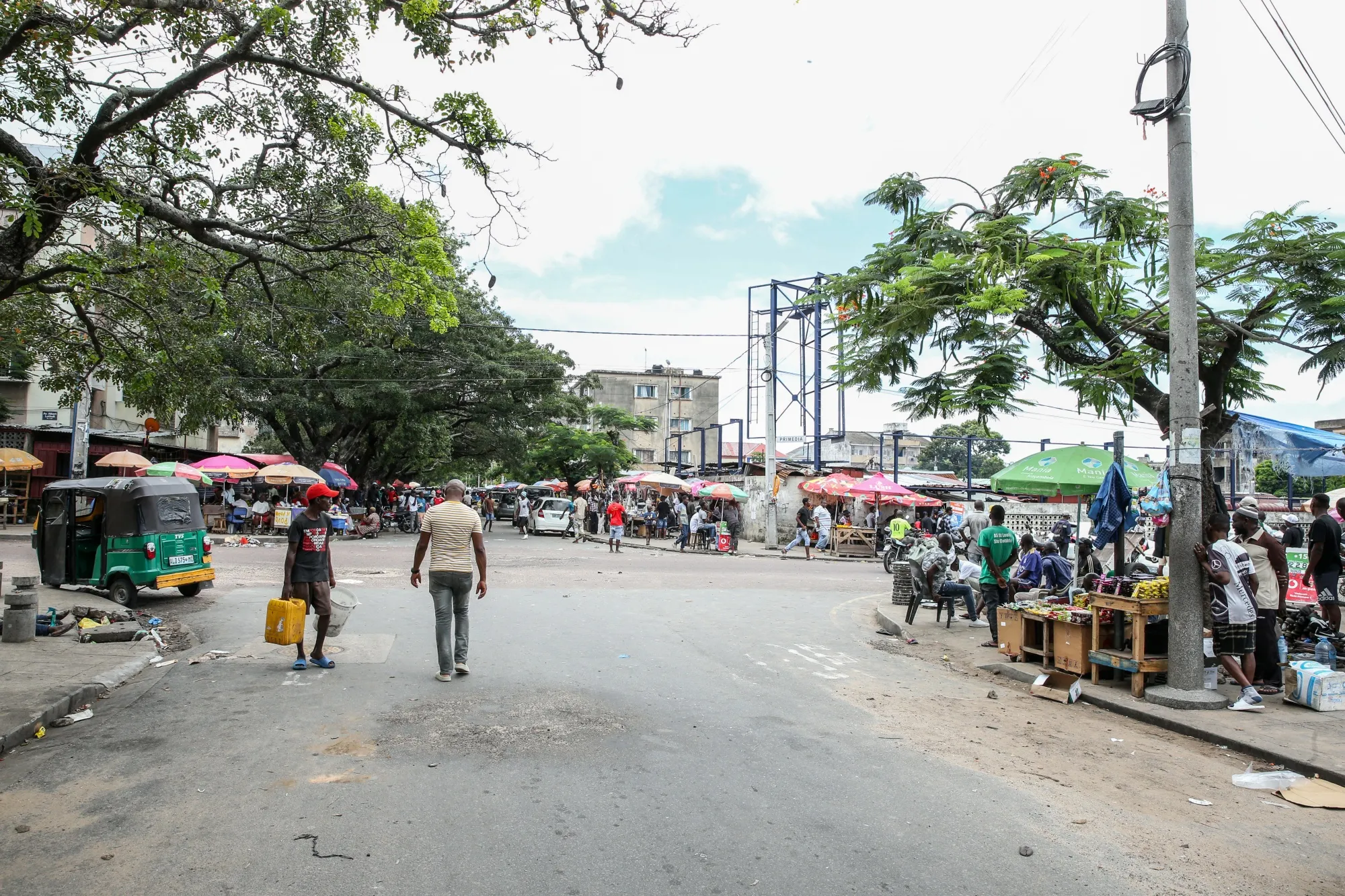 People gather next to street stalls in Maputo, Mozambique.&nbsp;