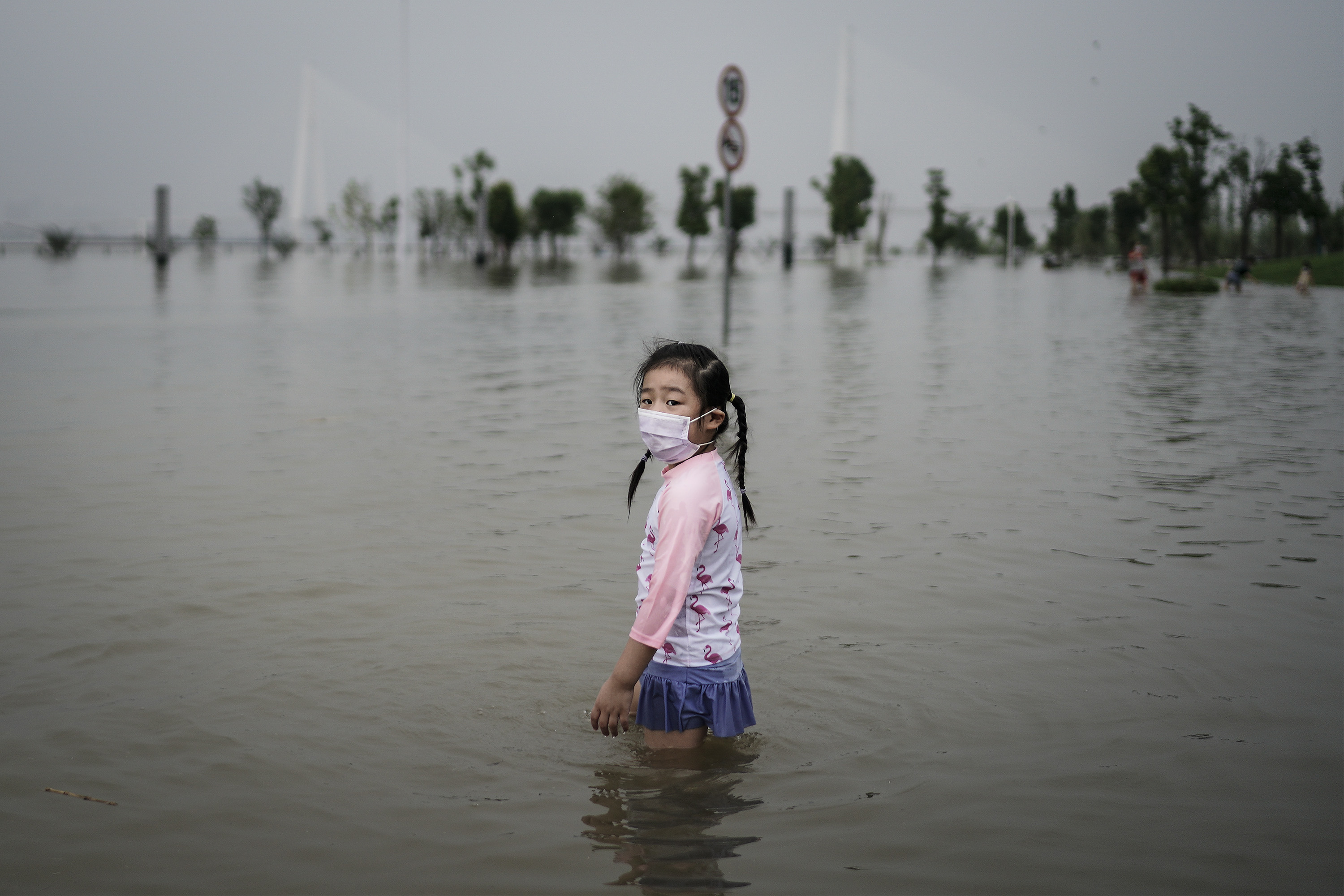 A girl plays in a flooded park in Wuhan on July 10.
