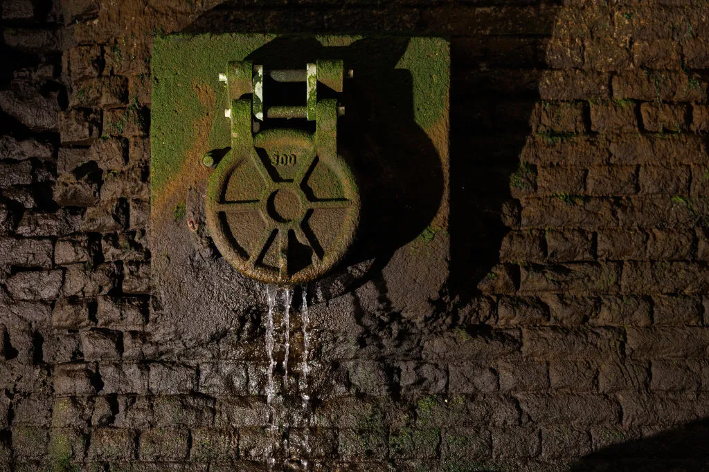 A overflow pipe releases water into the River Thames.