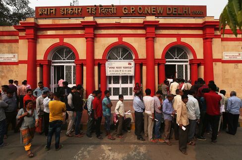 People stand in line to exchange now-defunct notes