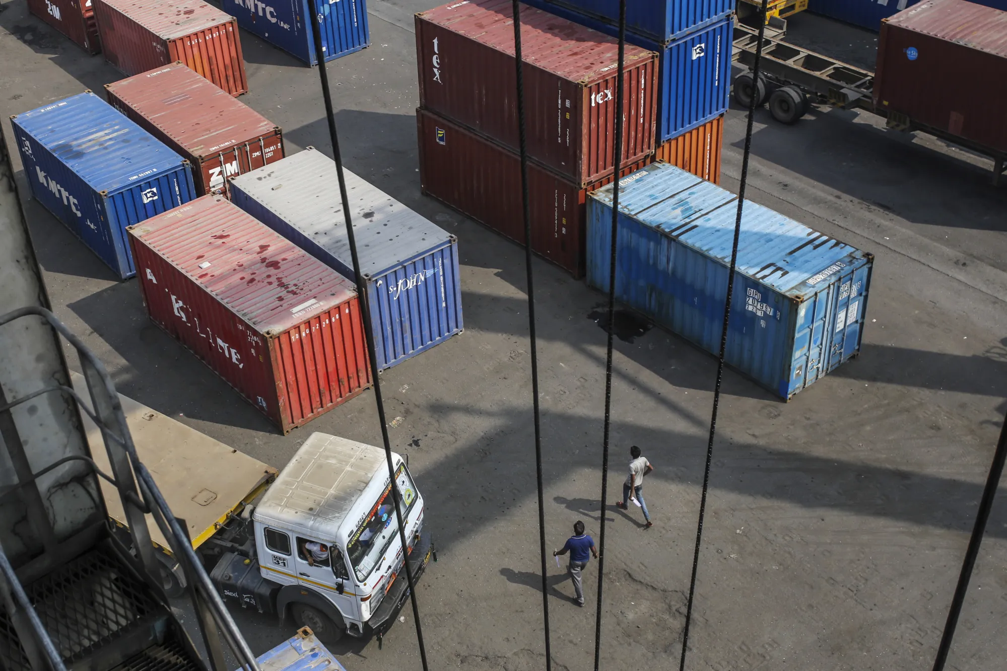 A truck sits parked next to shipping containers at the Jawaharlal Nehru Port, in Navi Mumbai, Maharashtra, India.