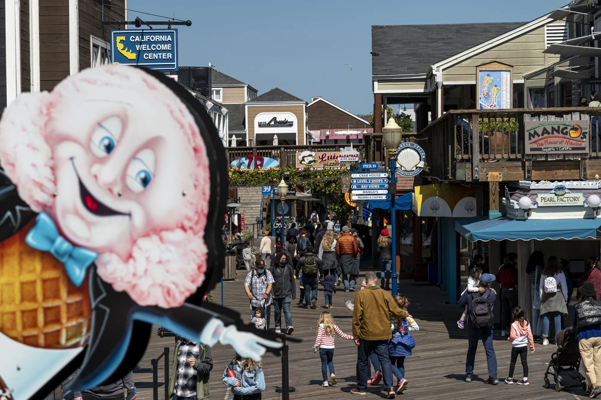 Pedestrians walk on Pier 39 in San Francisco.