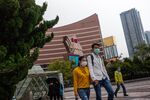 Pedestrians wearing protective masks walk in front of the Wynn Macau casino resort in Macau, China, on March 3. 