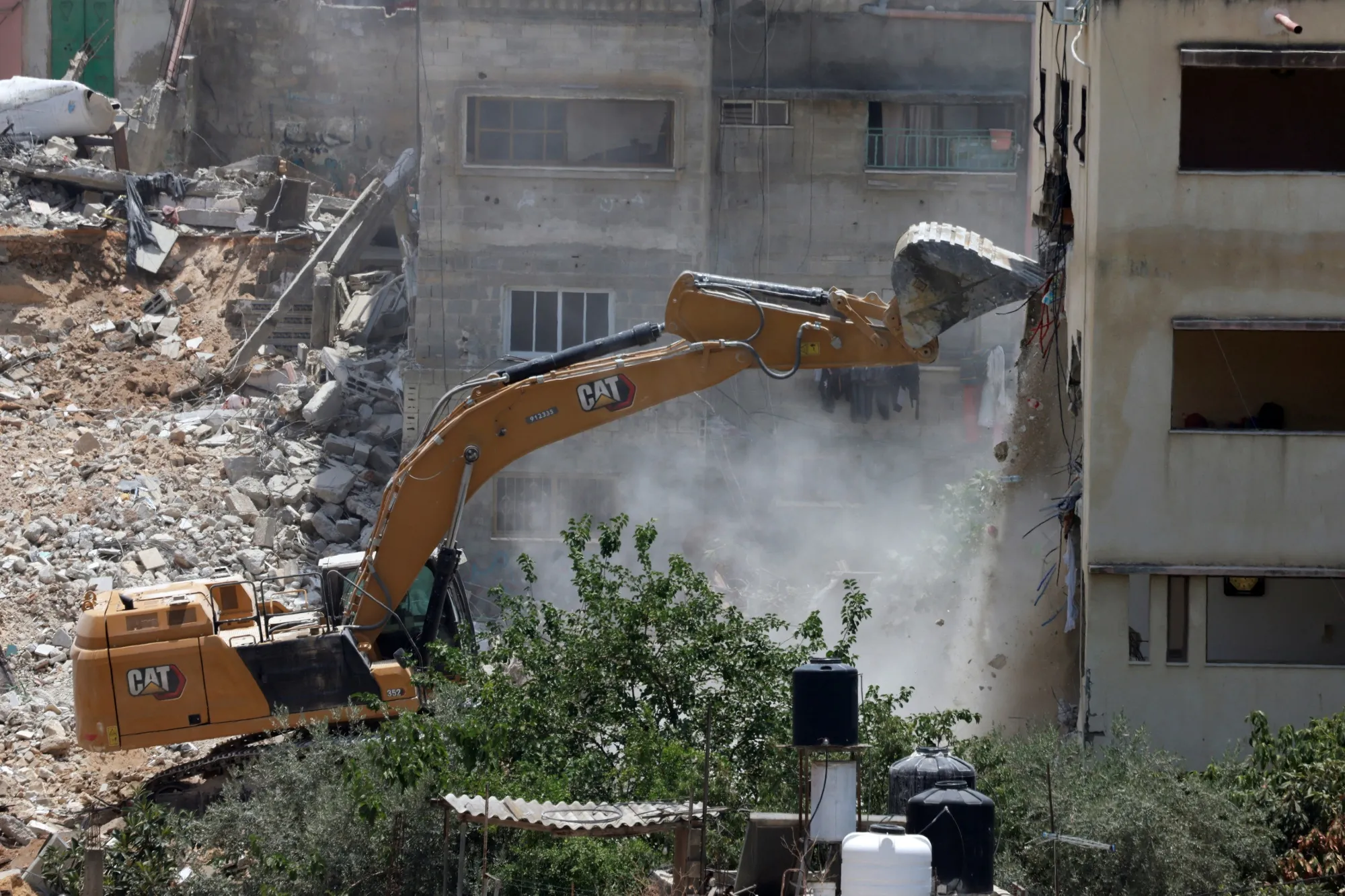 An Israeli military bulldozer demolishes a home at the Nur Shams Palestinian refugee camp in the Israeli occupied West Bank on June 23.