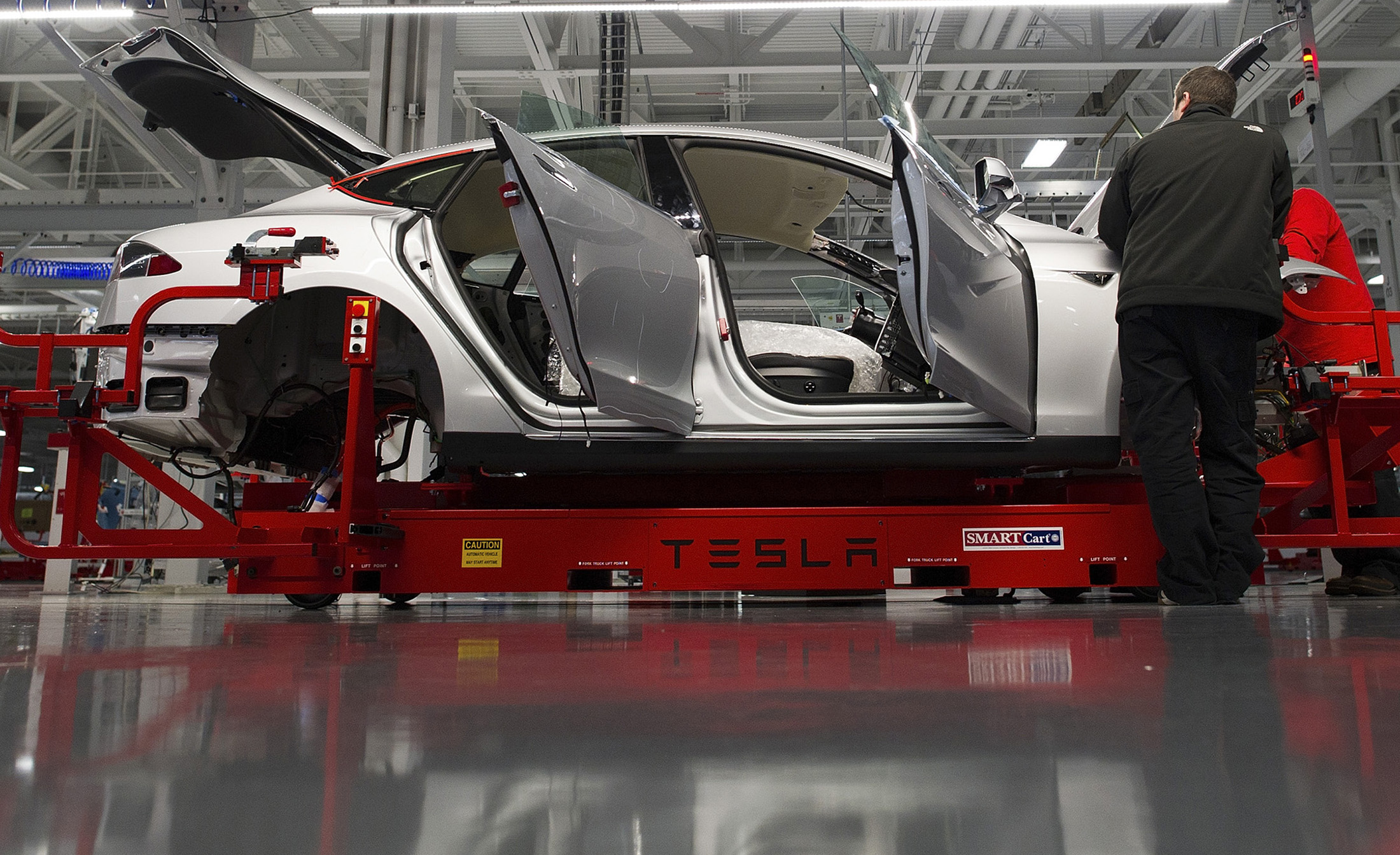 Tesla associates work on the Model S electric car at the company's factory in Fremont, California.
