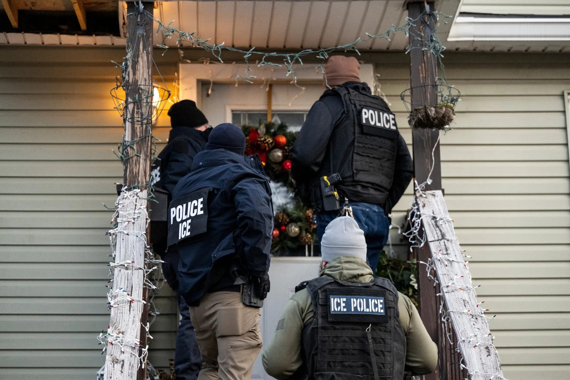 US Immigration and Customs Enforcement (ICE) agents knock on the door of a residence in Chicago, Illinois,&nbsp;during Sunday’s raids.