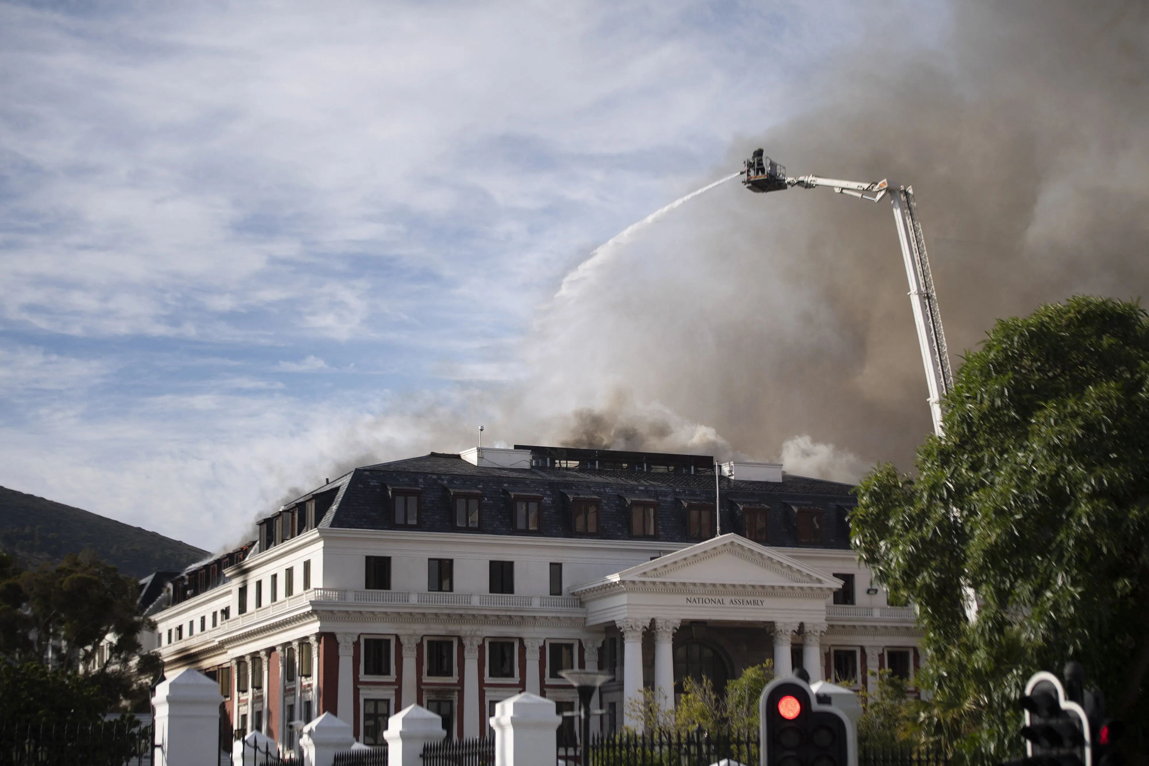 Firefighters are at work to extinguish a fire burning in the National Assembly, the main chamber of the South African Parliament buildings&nbsp;in Cape Town, on Jan. 3, 2022.