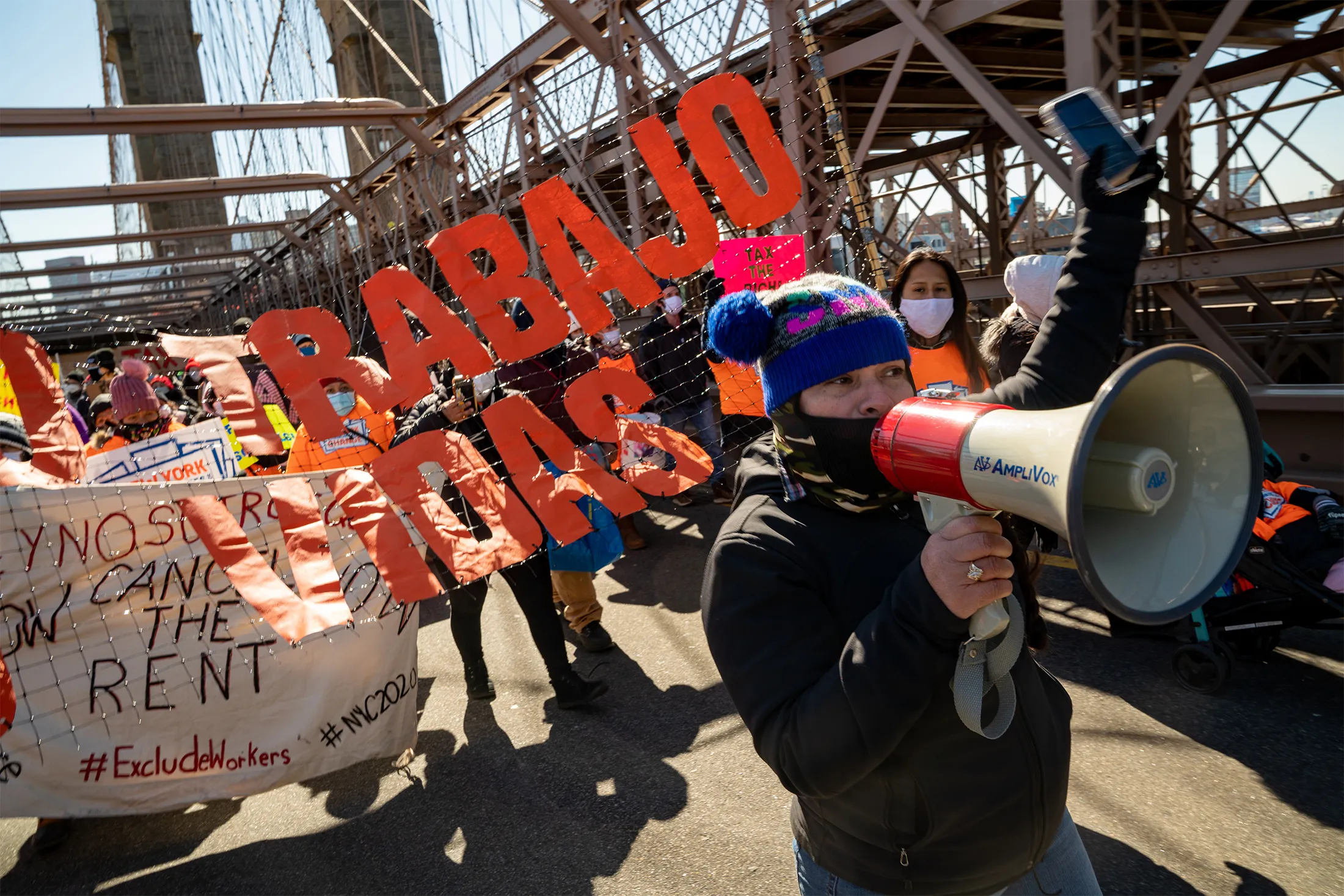 Protestors march across the Brooklyn Bridge in March&nbsp;to demand funding for excluded workers in the New York State budget.&nbsp;