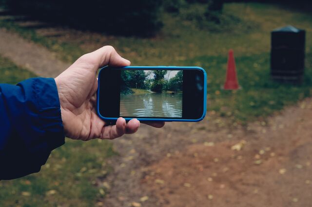 Ben Morris shows recent flooding on his phone by Wharncliffe Viaduct