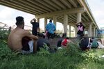 Migrants wait to be processed by the Border Patrol after illegally crossing the Rio Grande river from Mexico into the U.S. at Eagle Pass, Texas, Friday, Aug. 26, 2022. The number of Venezuelans, Cubans and Nicaraguans taken into custody at the U.S. border with Mexico soared in August as migrants from Mexico and traditional sending countries were stopped less frequently, authorities said Monday, Sept. 19. (AP Photo/Eric Gay, File)