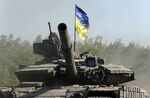 Ukrainian troops ride a tank on a road in the eastern Ukrainian region of Donbas on June 21.