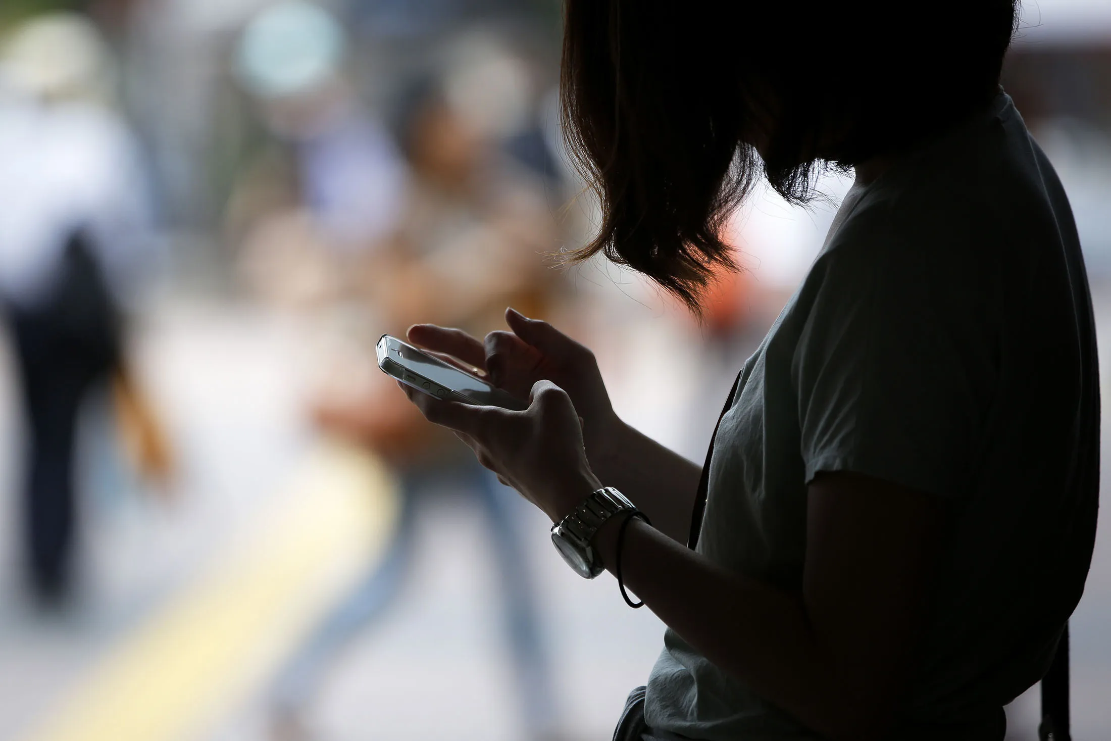 A woman uses her smartphone in Tokyo, Japan.
