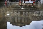 The Bank of England is reflected in a puddle&nbsp;in London.