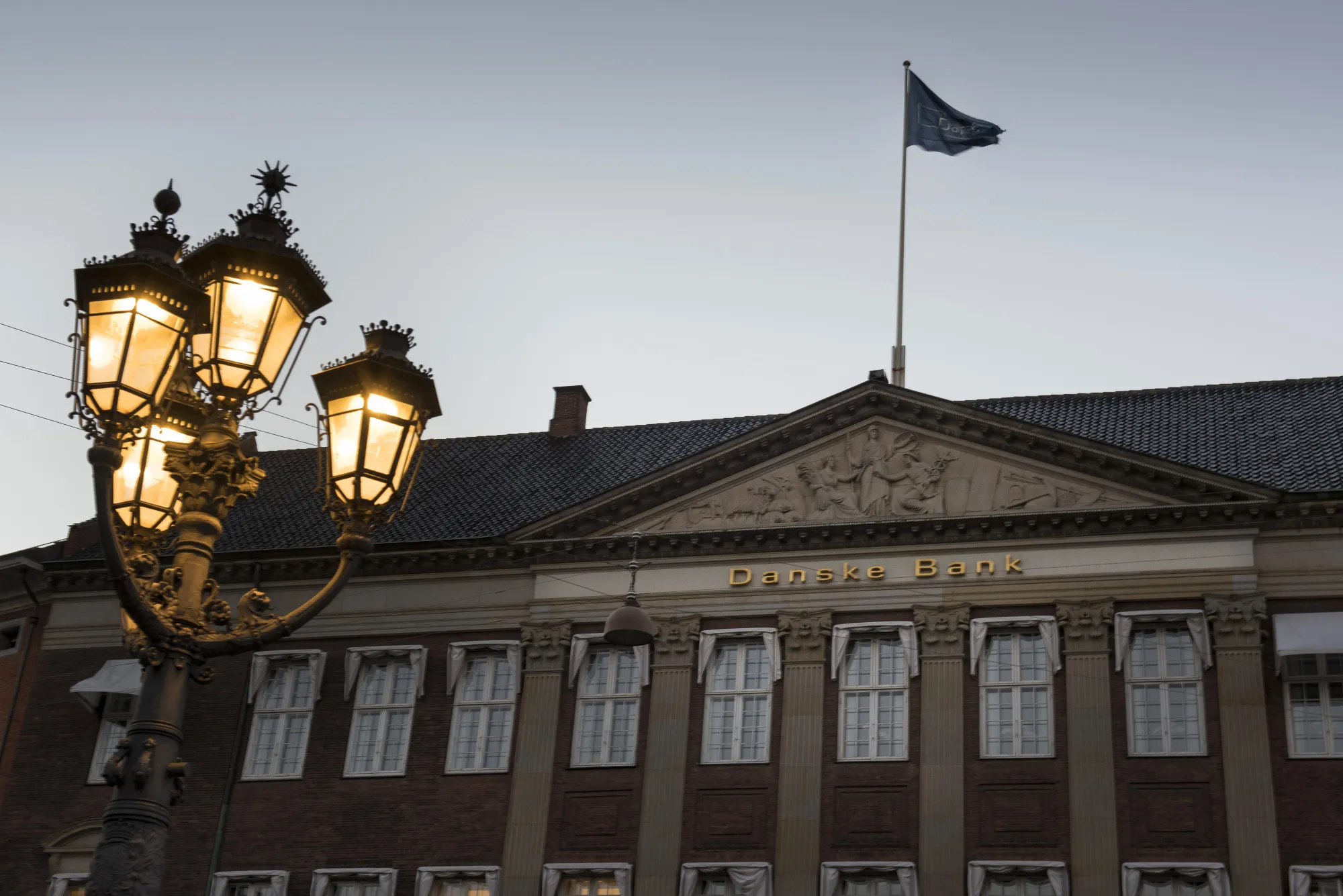 A flag flies above the headquarters of Danske Bank A/S in Copenhagen.