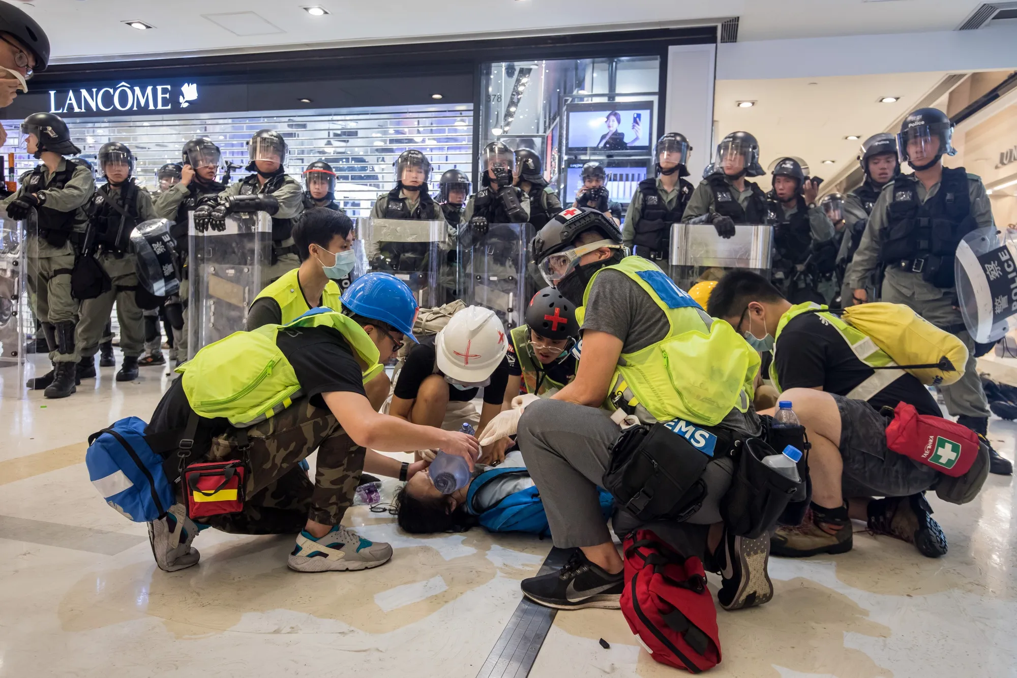 Medical volunteers treat a demonstrator inside New Town Plaza shopping mall on Sunday.