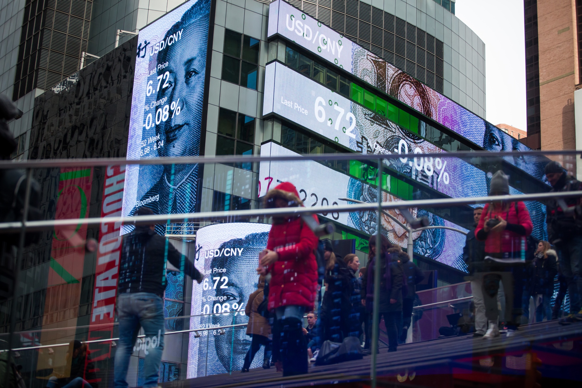 Monitors display the U.S. Dollar and China Renminbi&nbsp;exchange rate outside Morgan Stanley headquarters in New York.