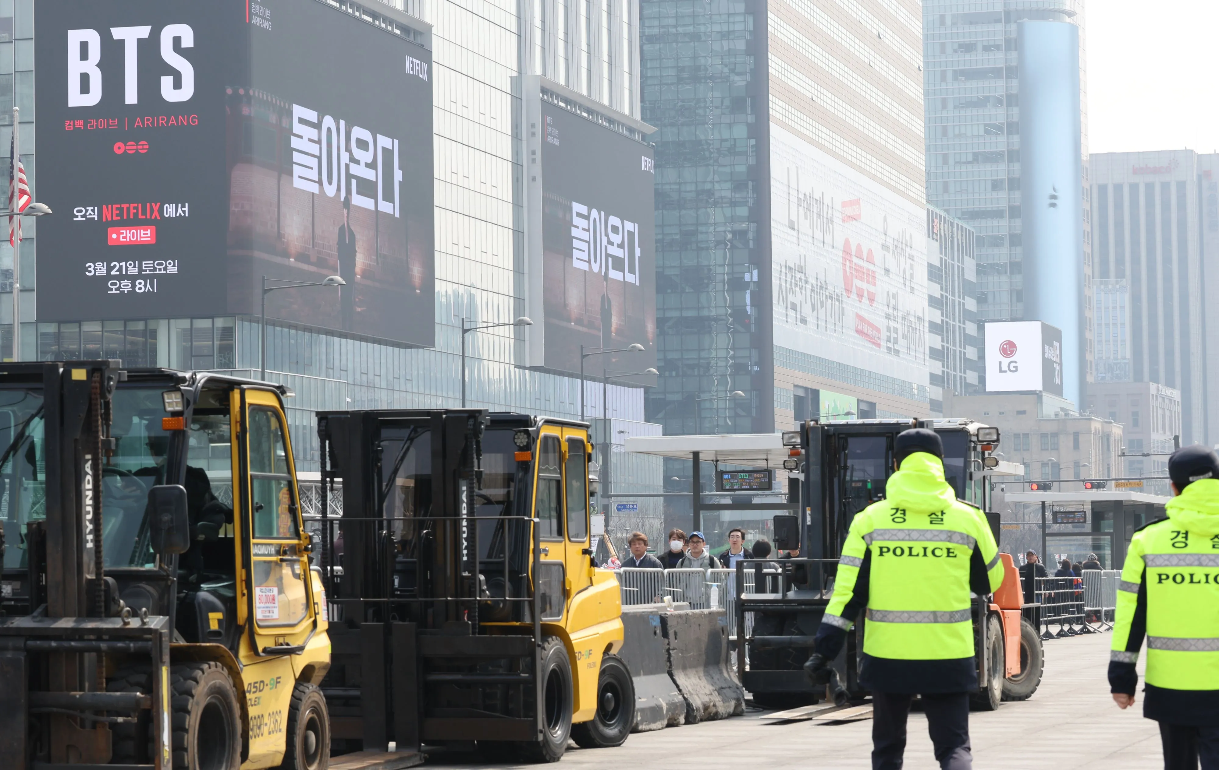 Workers set up the stage for the free concert by BTS at Gwanghwamun Square in Seoul, on March 16.