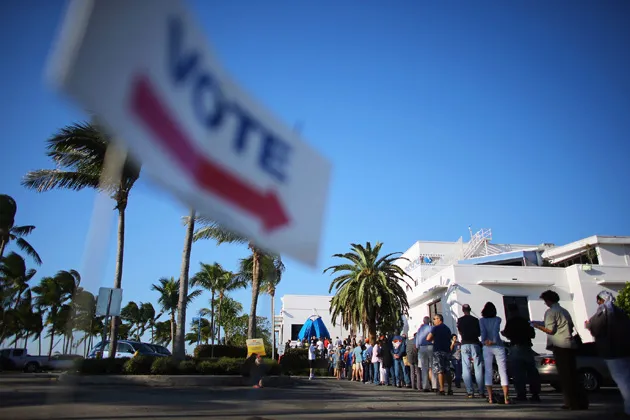 Early voters wait in line to vote in the presidential election on the first day of early voting at a polling station setup at the City of Miami City Hall on Oct. 27, 2012 in Miami, FL