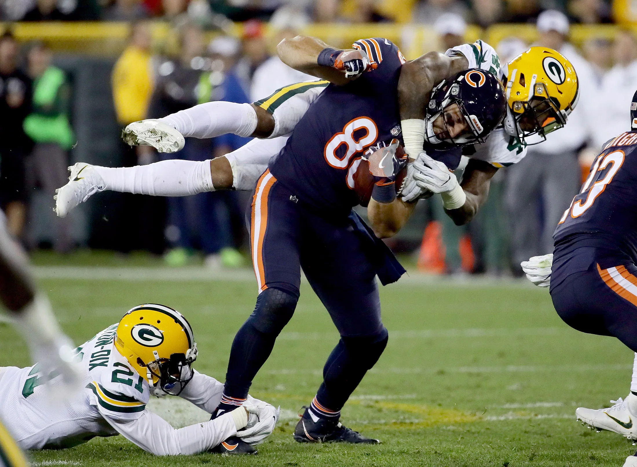 Morgan Burnett #42 of the Green Bay Packers tackles Zach Miller #86 of the Chicago Bears in the second quarter at Lambeau Field in Green Bay, Wisconsin, on Sept. 28.
