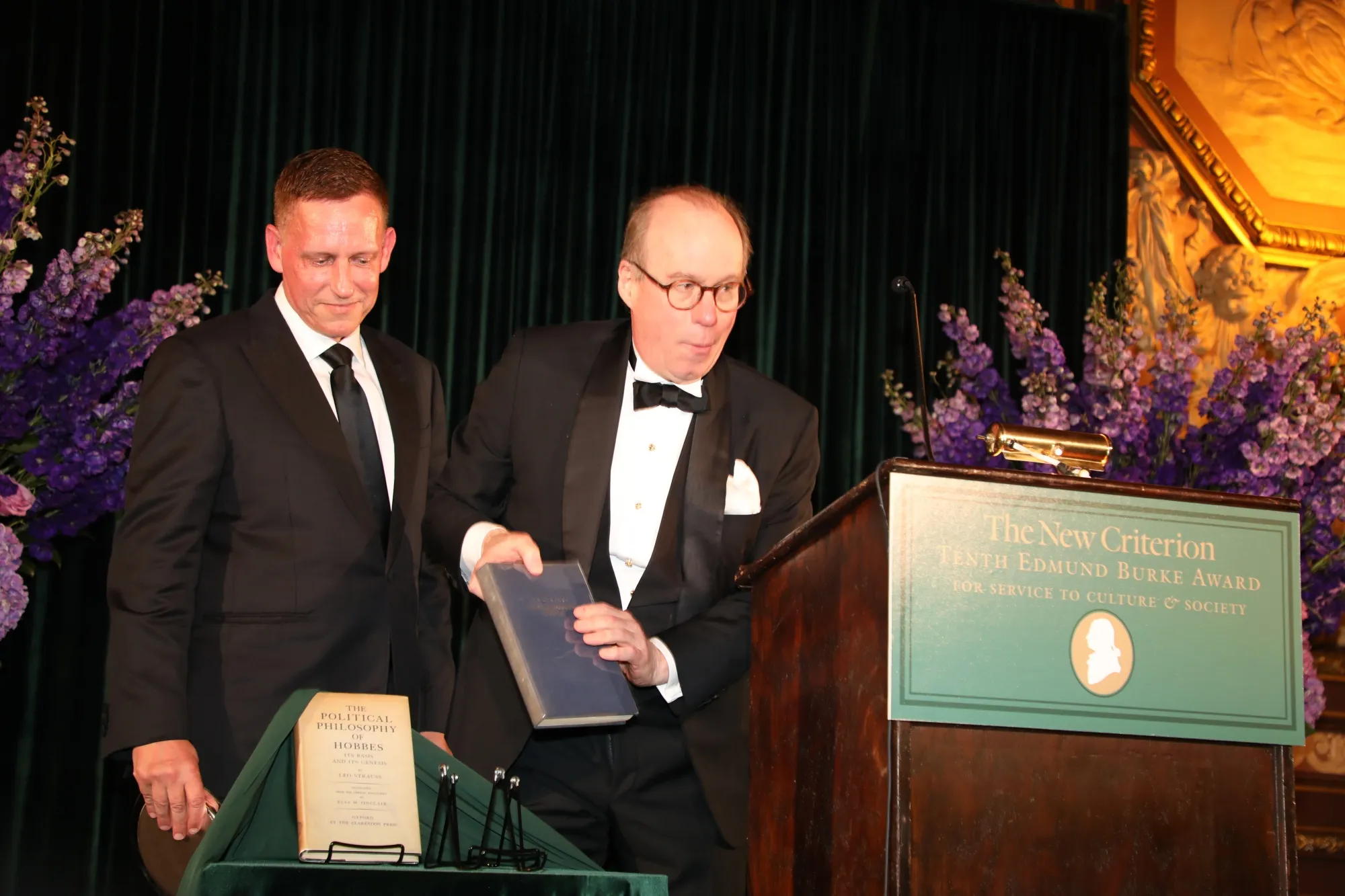 Peter Thiel accepts an award, plus books, from New Criterion Editor and Publisher Roger Kimball.
