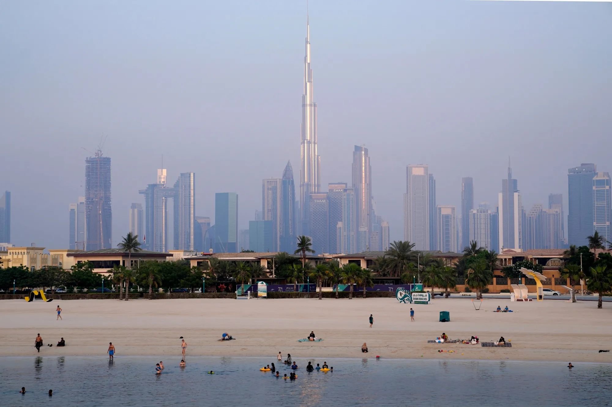 People cool off in the sea in Dubai.