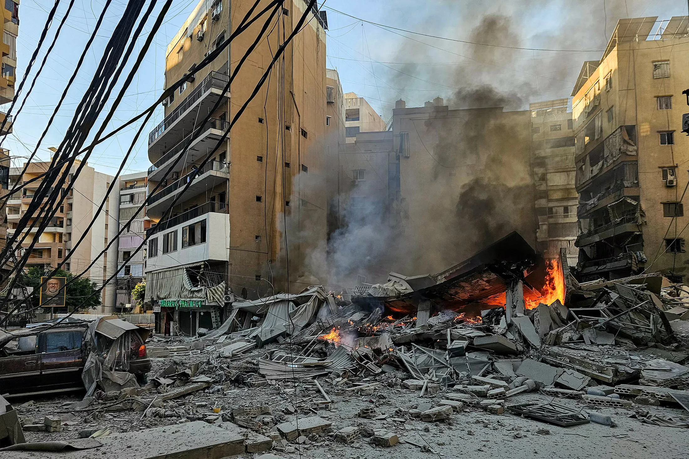 A fire burns at the site of a collapsed building following an Israeli airstrike on Beirut's southern suburbs on March 9.&nbsp;