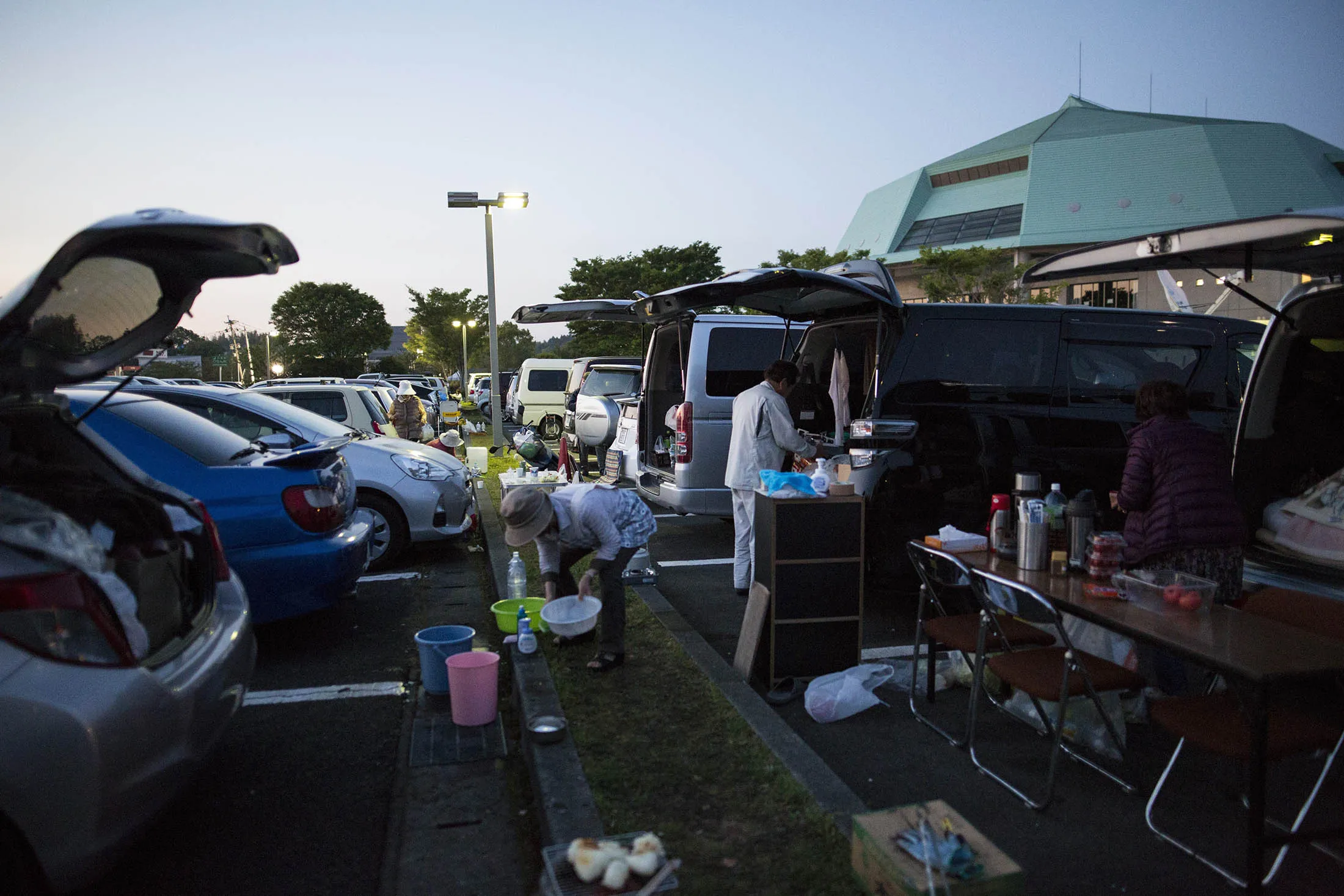 Residents at the car park of Mashiki Gymnasium evacuation center in Kumamoto on April 19.
