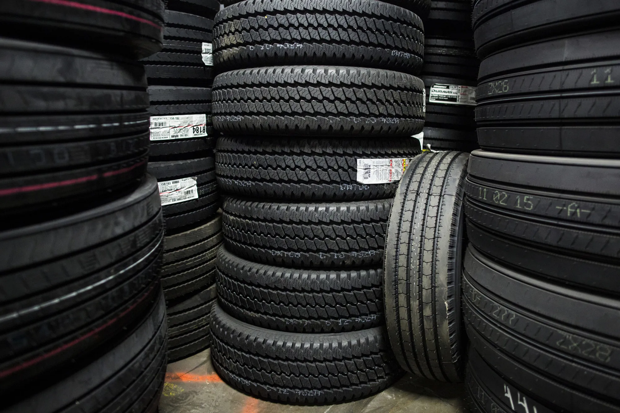 Bridgestone Corp. tires sit stacked at a warehouse in Nashville, Tennessee, U.S., on Tuesday, Dec. 29, 2015. Pep Boys shares jumped 8.8 percent after Carl Icahn raised his takeover offer for the auto-parts chain to more than $1 billion, escalating a bidding war with Bridgestone.
