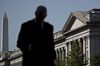 A pedestrian walks near the U.S. Treasury building in Washington, D.C., U.S., on Monday, July 16, 2018. The House this week plans to consider a minibus spending bill that combines legislation funding the Treasury, Internal Revenue Service (IRS), and the Securities and Exchange Commission (SEC) with another bill keeping the Interior Department and Environmental Protection Agency (EPA) running.