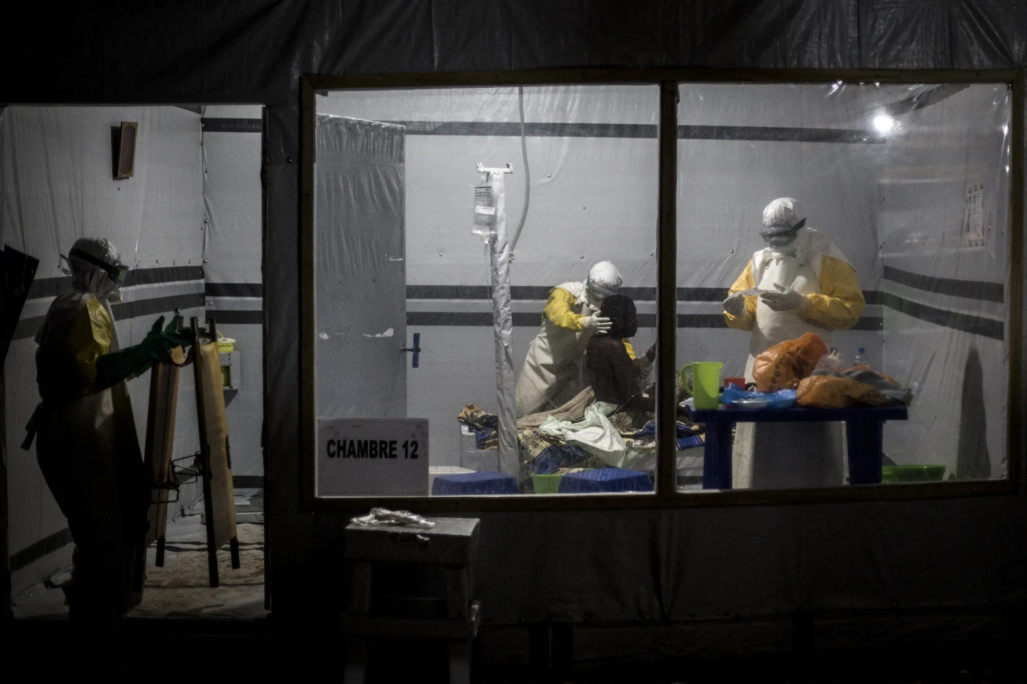 Health workers treat an unconfirmed Ebola patient, inside an Ebola Treatment Centre in Butembo, Democratic Republic of the Congo in 2018.