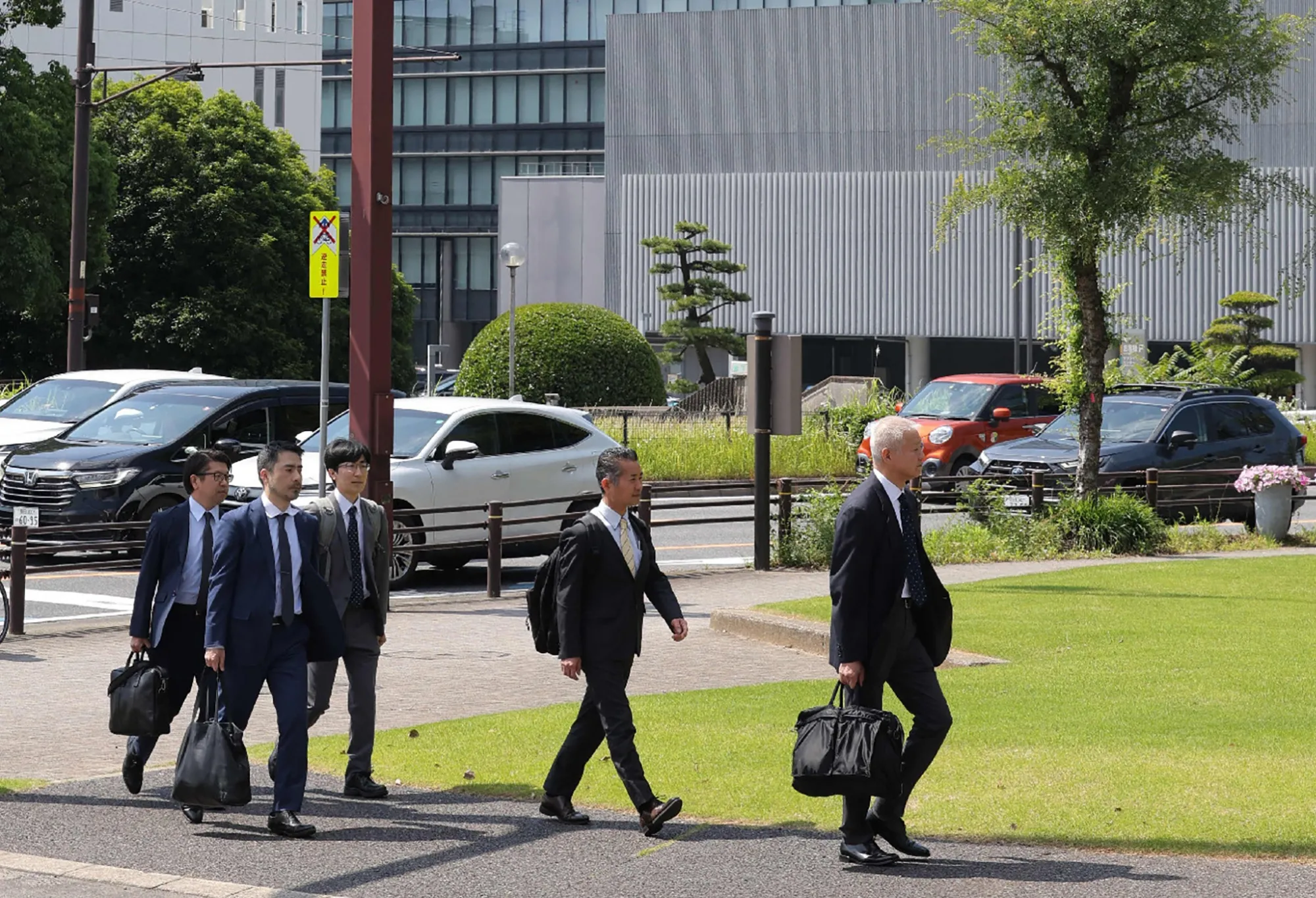 Officials from the transport ministry arrive for an inspection at Toyota Motor Corp. headquarters in Toyota City, Japan, on June 4.