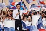Emmanuel Macron surrounded by supporters, speaks during an election campaign meeting in Marseille.