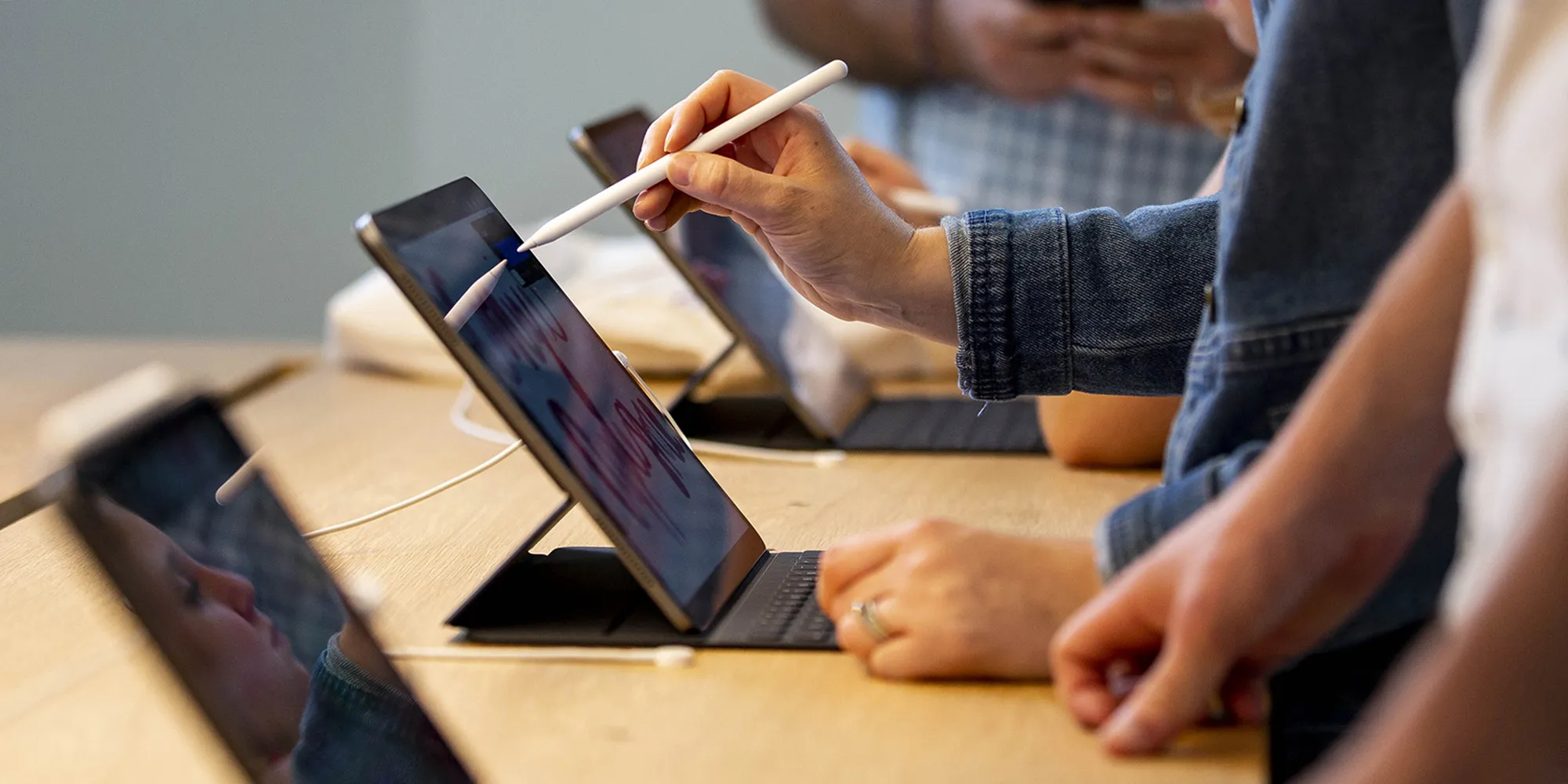 Attendees use a drawing program on an iPad tablet during the opening of the new Apple Inc. Carnegie Library store at Mount Vernon Square in Washington, D.C.