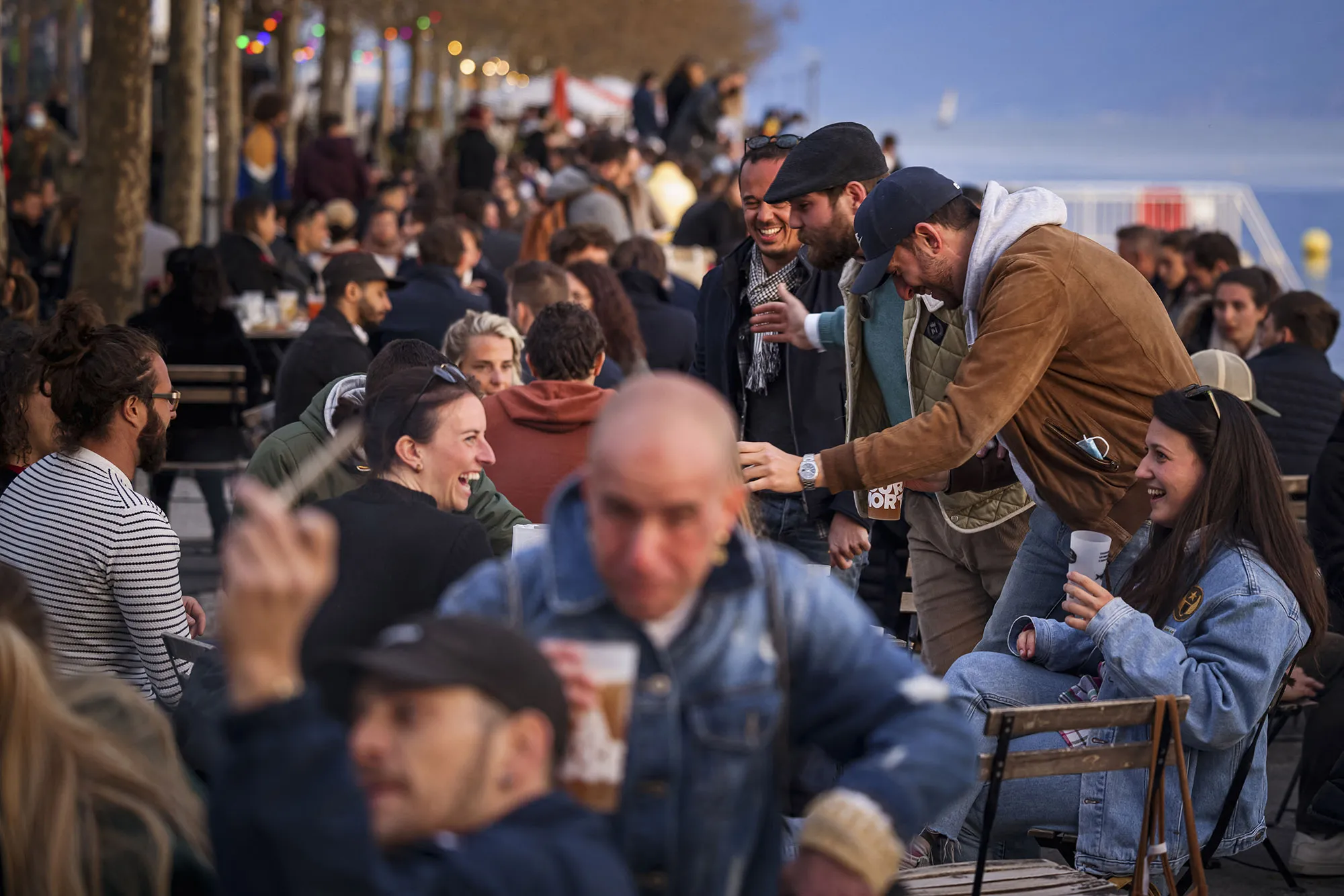 Customers gather on a terrace beside Lake Geneva in Lausanne, on April 19.