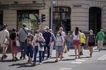 Pedestrians wearing protective face masks walk across a crosswalk on Principe de Vergara street in Madrid, on July 24.