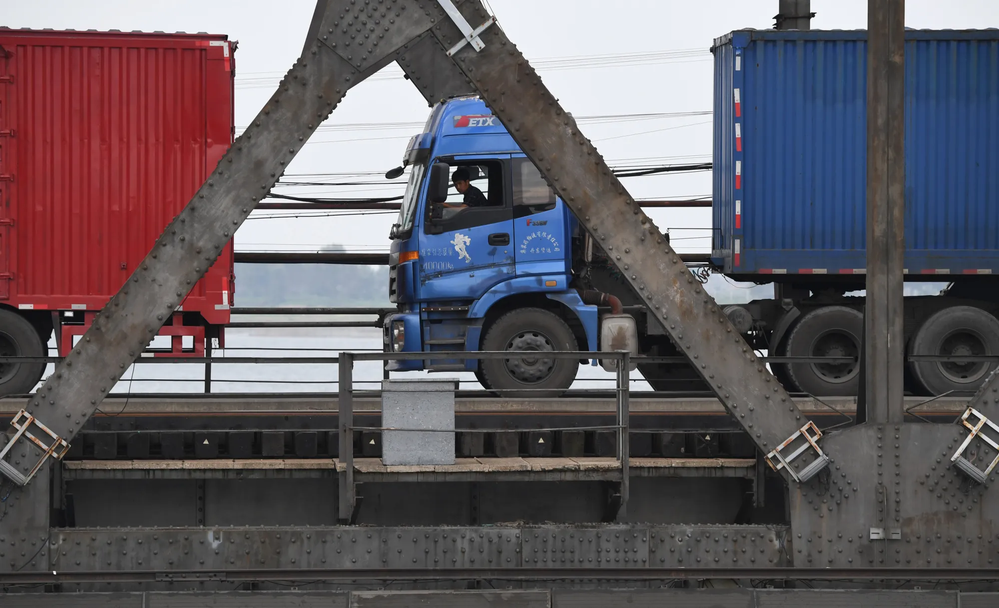 Trucks cross the Friendship Bridge from North Korea to China.
