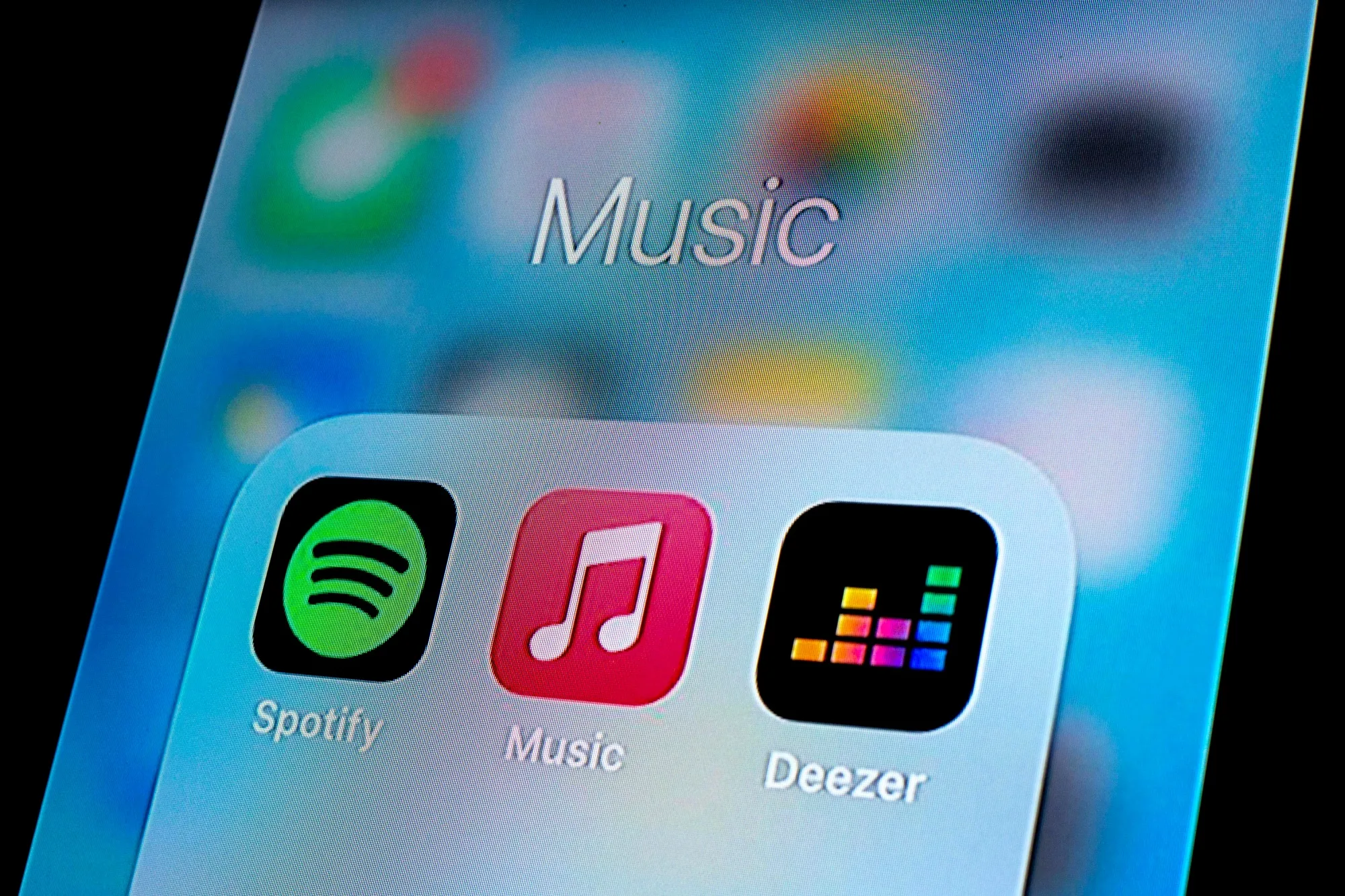 In this photo illustration, a Spotify app, Apple Music app