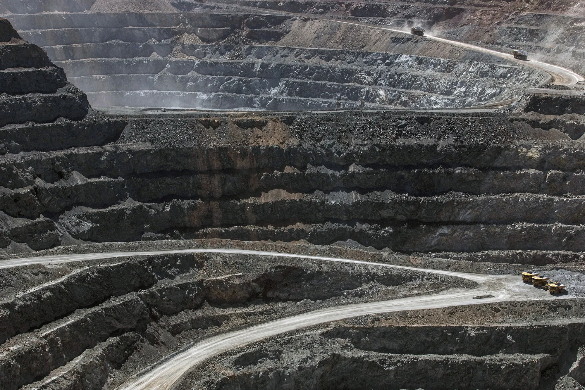 Dump trucks operate in an open pit at the Oyu Tolgoi copper-gold mine, jointly owned by Rio Tinto Group's Turquoise Hill Resources Ltd. unit and state-owned Erdenes Oyu Tolgoi LLC, in Khanbogd, the South Gobi desert, Mongolia, on Saturday, July 23, 2016. Mongolia exported 817,000 tons of copper concentrate in the first half of the year compared with 663,800 tons a year earlier, an increase of 23.1 percent.

