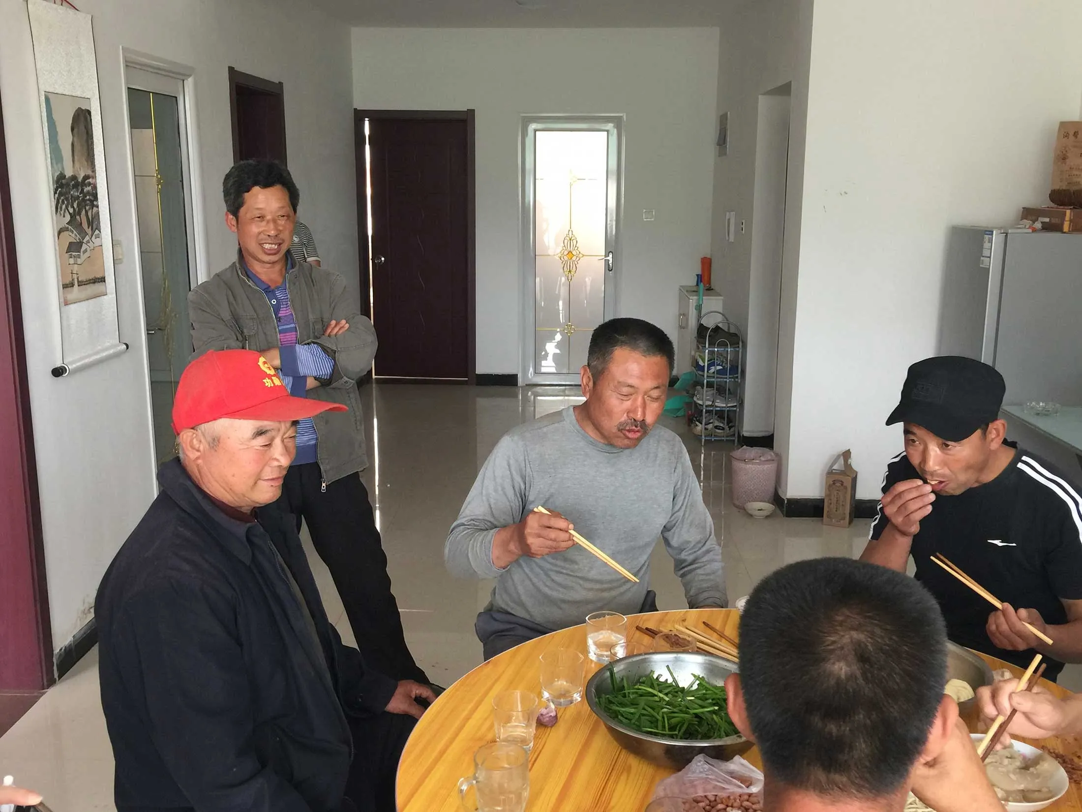 Men having lunch at Liang Fucai’s home.