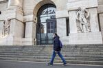 A pedestrian wearing a protective face masks passes the Milan Stock Exchange in Milan, Italy, on Monday, Feb. 24, 2020.