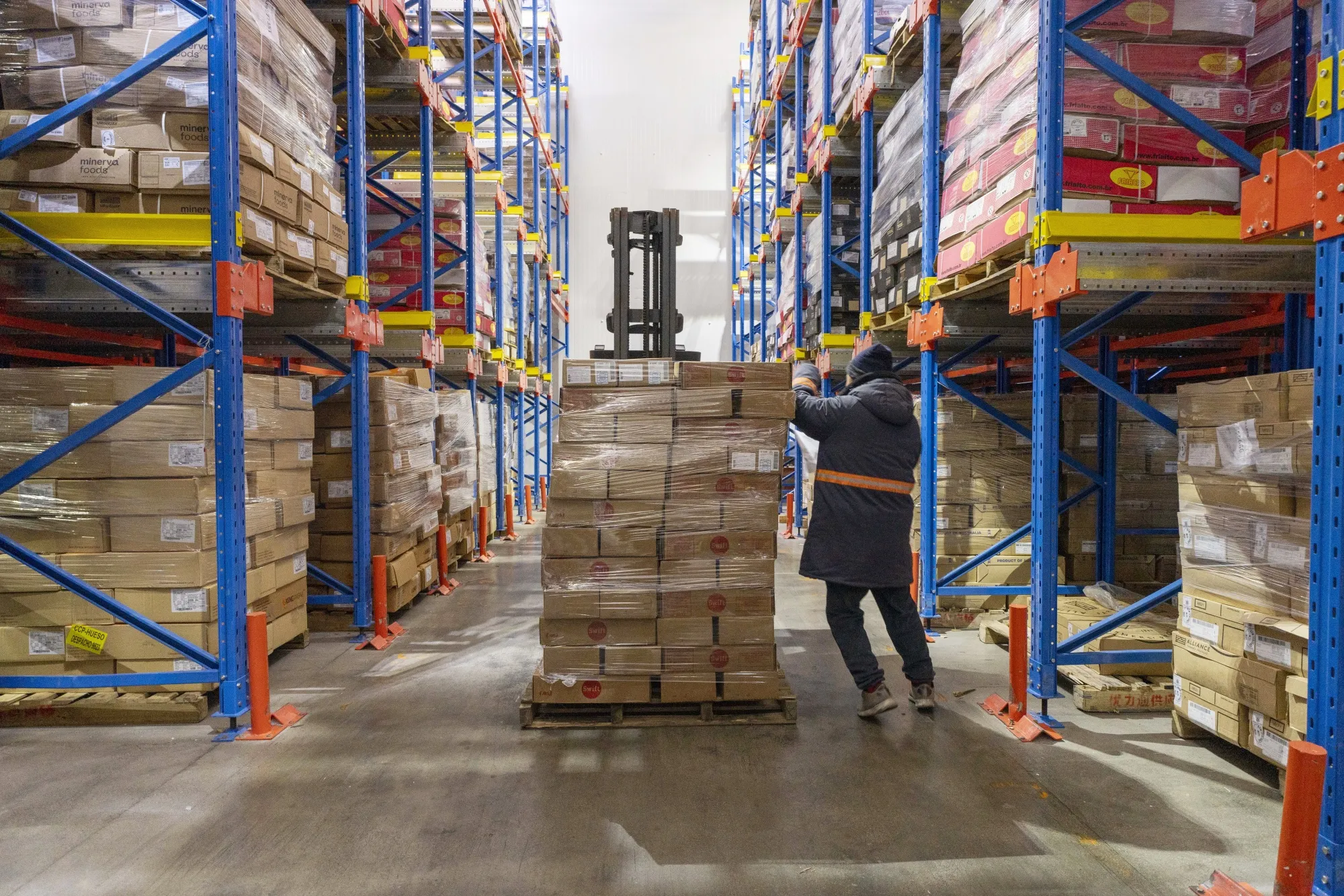 A worker arranges boxes of imported pork from the US at a cold storage warehouse in Shanghai&nbsp;on March 5.